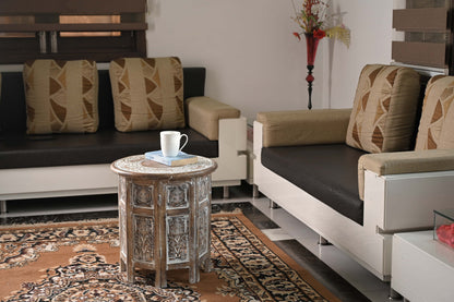 Runder Couchtisch aus handgefertigtem Mangoholz im Wohnzimmer mit Sofas und Dekokissen